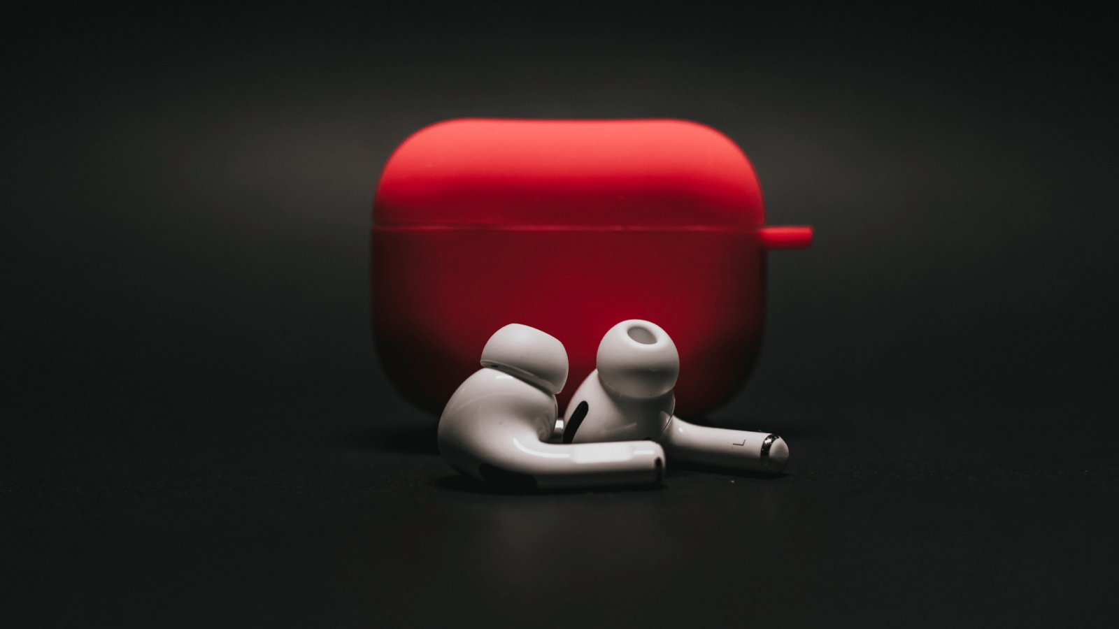 are airpods case covers worth it? image of a red case cover for Airpods on a black background